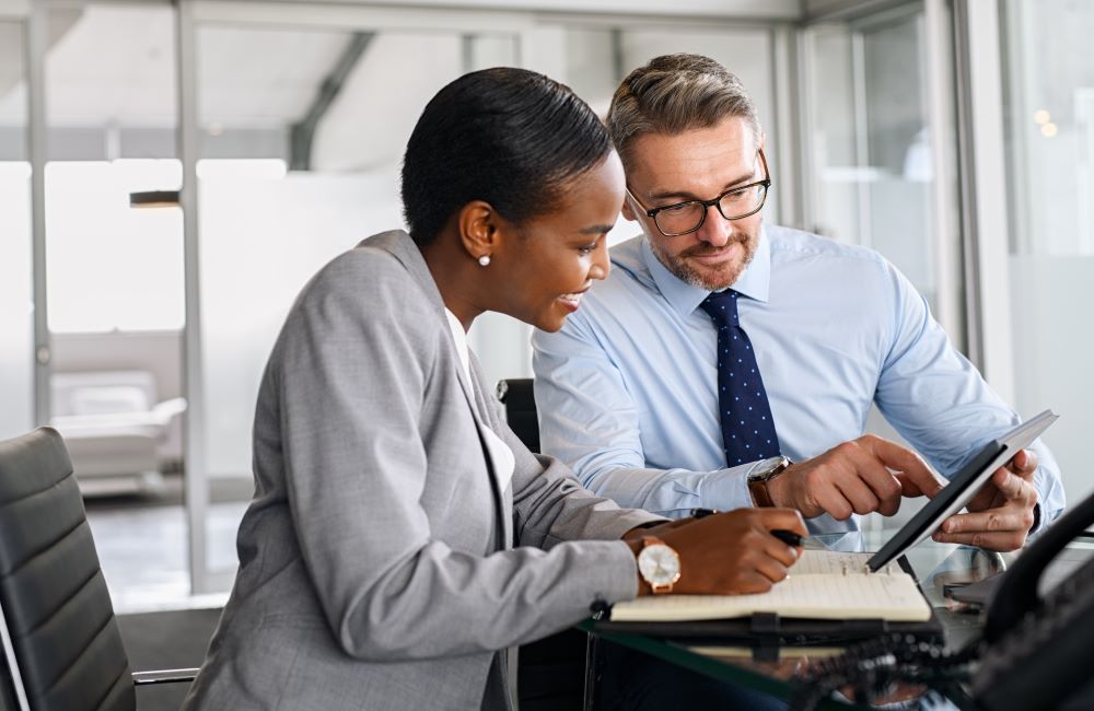 Business partners working on digital tablet in modern office